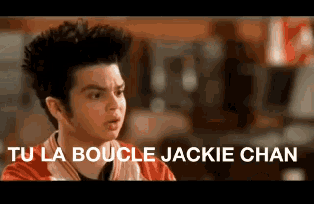a man in a red jacket with the words tu la boucle jackie chan above him