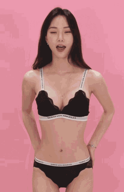 a woman in a black guess los angeles bra and panty