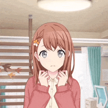 a girl in a pink sweater is standing in a room