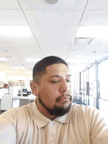 a man with a beard is taking a selfie
