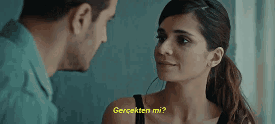 a man and a woman are looking at each other and the woman says " gerçekten mi ? "