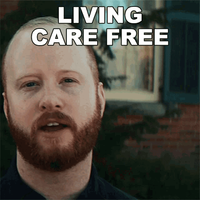 a man with a beard is smiling with the words living care free above him