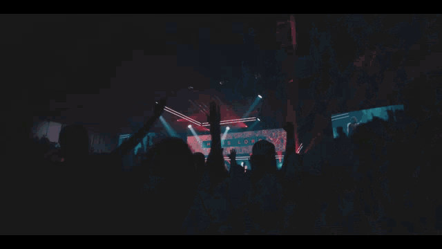 a man in a hooded jacket is dancing in front of a crowd