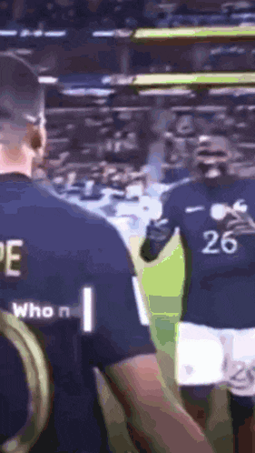 a soccer player wearing a jersey with the number 26 on the back