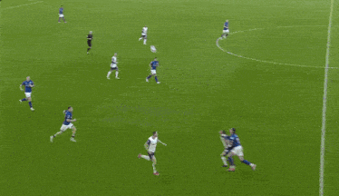 a soccer game is being played in front of a crowd and a scoreboard that says premier league on it