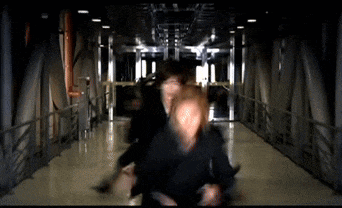 a blurry picture of a man in a black suit running