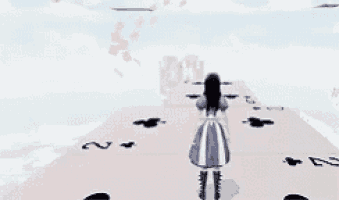 alice from alice in wonderland is standing on a playing card board .