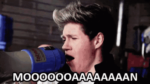 a man is holding a megaphone in his mouth and screaming ..