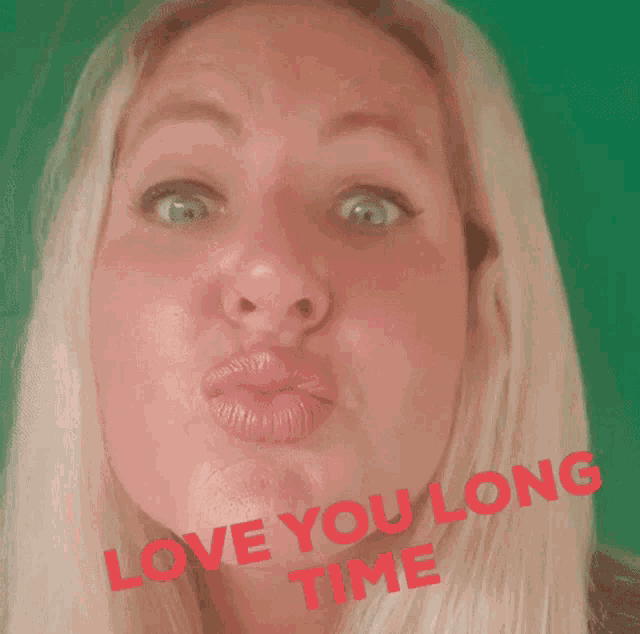 a woman is making a funny face with the words love you long time written on her face