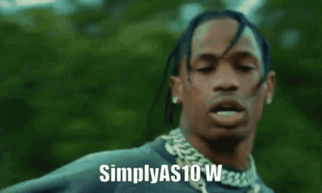 a man with dreadlocks says simplyas10w in front of a green background