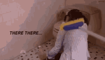 a woman is sitting in a bathroom next to a toilet with a sponge on her neck .