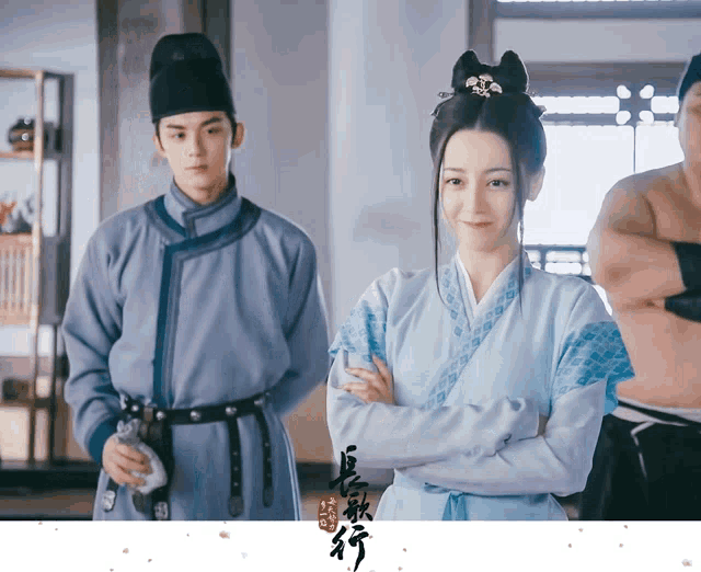 a man and a woman are standing next to each other with chinese writing on the bottom right