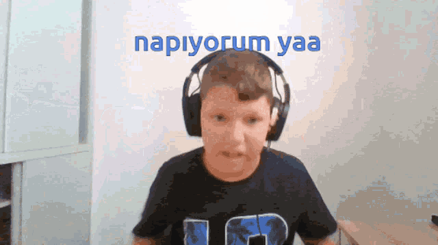 a boy wearing headphones with the word napiyorum yaa on the bottom
