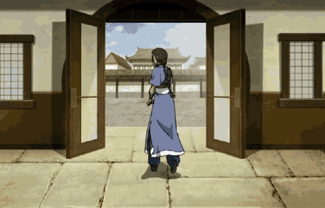 a woman in a blue dress is standing in front of a door