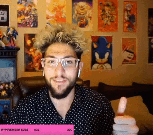 a man giving a thumbs up in front of a sign that says hypevember subs 631