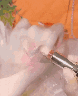 a person is applying lipstick to another person 's wrist