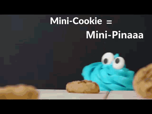 a cookie monster with big eyes is standing next to a cookie on a table