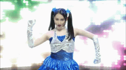 a woman in a blue dress and white gloves dancing