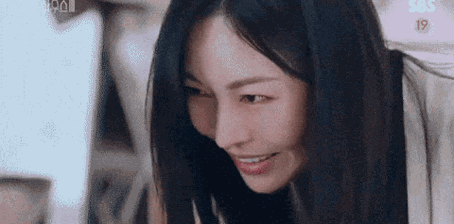 a close up of a woman 's face with a blurred background