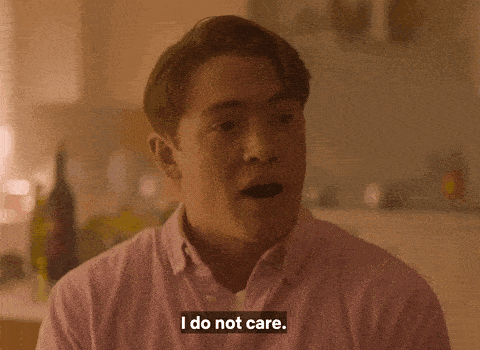 a man says i do not care in a pink shirt