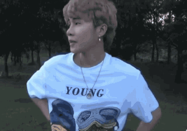 a young man is wearing a white t-shirt with the word young on it