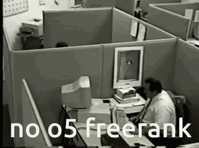 a man sits at a desk in a cubicle with the words " no 05 freerank " written above him