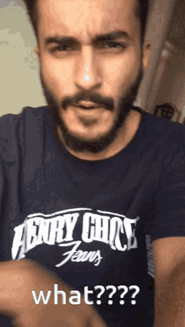 a man with a beard is wearing a henry chick jeans t-shirt