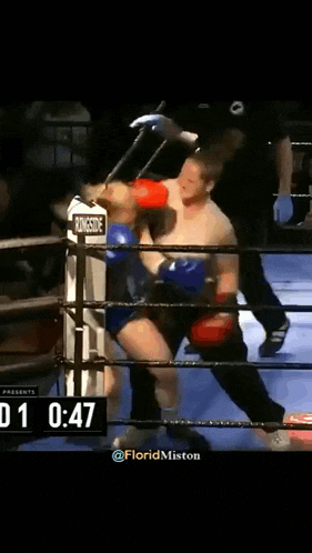 a man in a boxing ring with a scoreboard that says rd 1 0:17 on it