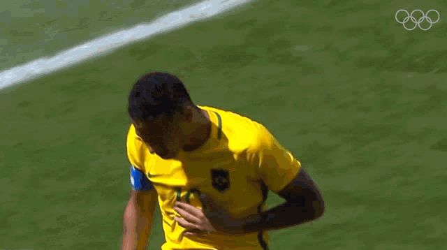 a soccer player in a yellow shirt with the number 10 on it