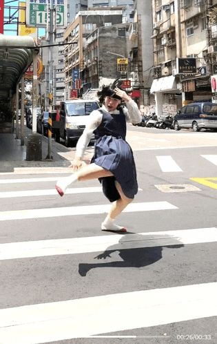 a person crossing a street with a green sign that says 1