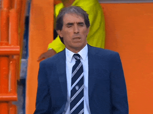 a man in a suit and tie has a badge on his shirt that says ' ucsd '