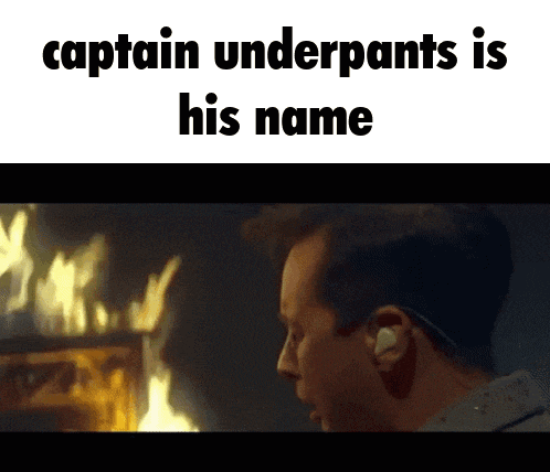 a man standing in front of a fire with the words " captain underpants is his name "