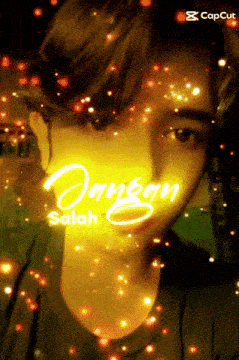 a man 's face is surrounded by glowing lights and the name jangan salah is written on it