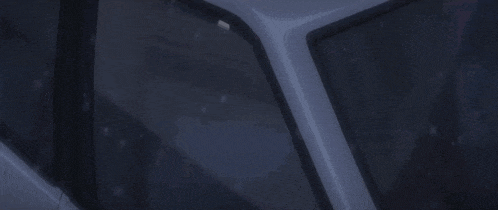 a man in a suit and tie is looking out of the window of a car