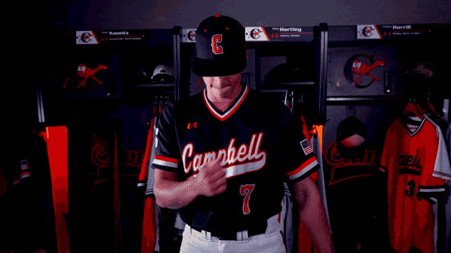 a baseball player wearing a black jersey with the number 2 on the front