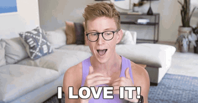 a man with glasses and a purple tank top says " i love it "