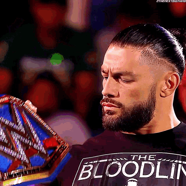 roman reigns is wearing a black shirt that says the bloodline on it