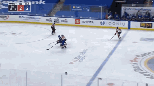 a hockey game is being played with advertisements for geico and tim hortons on the ice