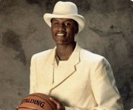 a man wearing a white suit and hat holds a spalding basketball