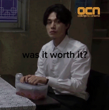 a man in a white shirt is sitting at a table with the words was it worth it
