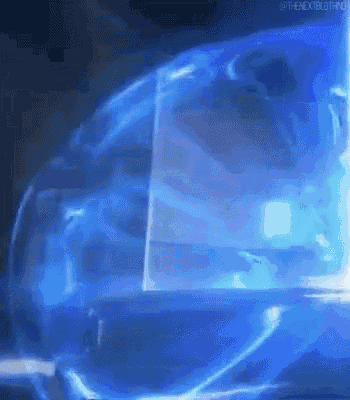 a close up of a blue light coming out of a glass in a dark room .