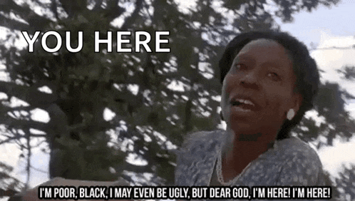 a woman is standing in front of a tree and says you here .