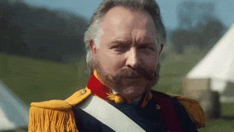 a man with a beard and mustache is wearing a uniform