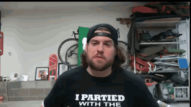 a man wearing a t-shirt that says i partied with the