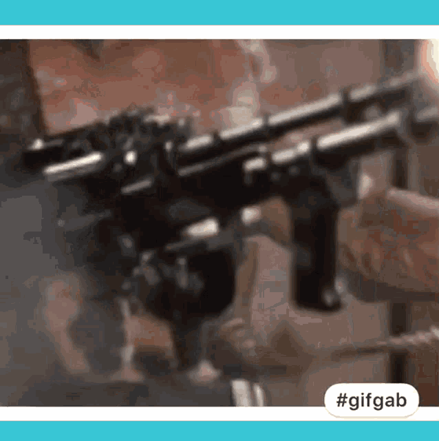 a person is holding a gun with smoke coming out of it