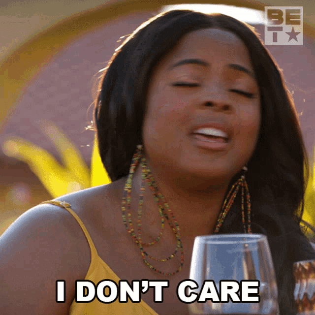 a woman says i don 't care while holding a glass of wine
