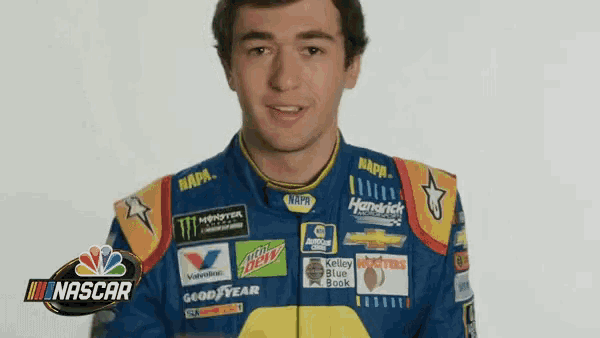 a man wearing a napa racing jacket is smiling