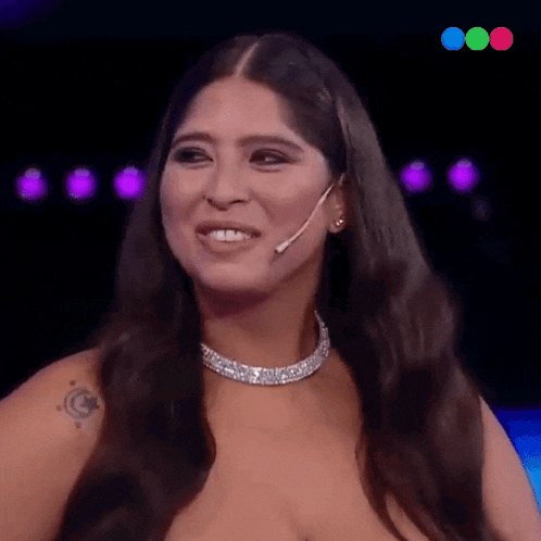 a woman with long hair is wearing a necklace and earrings