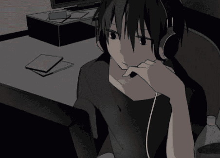a person wearing headphones is sitting in front of a computer .