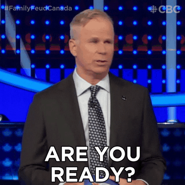 a man in a suit and tie is saying are you ready